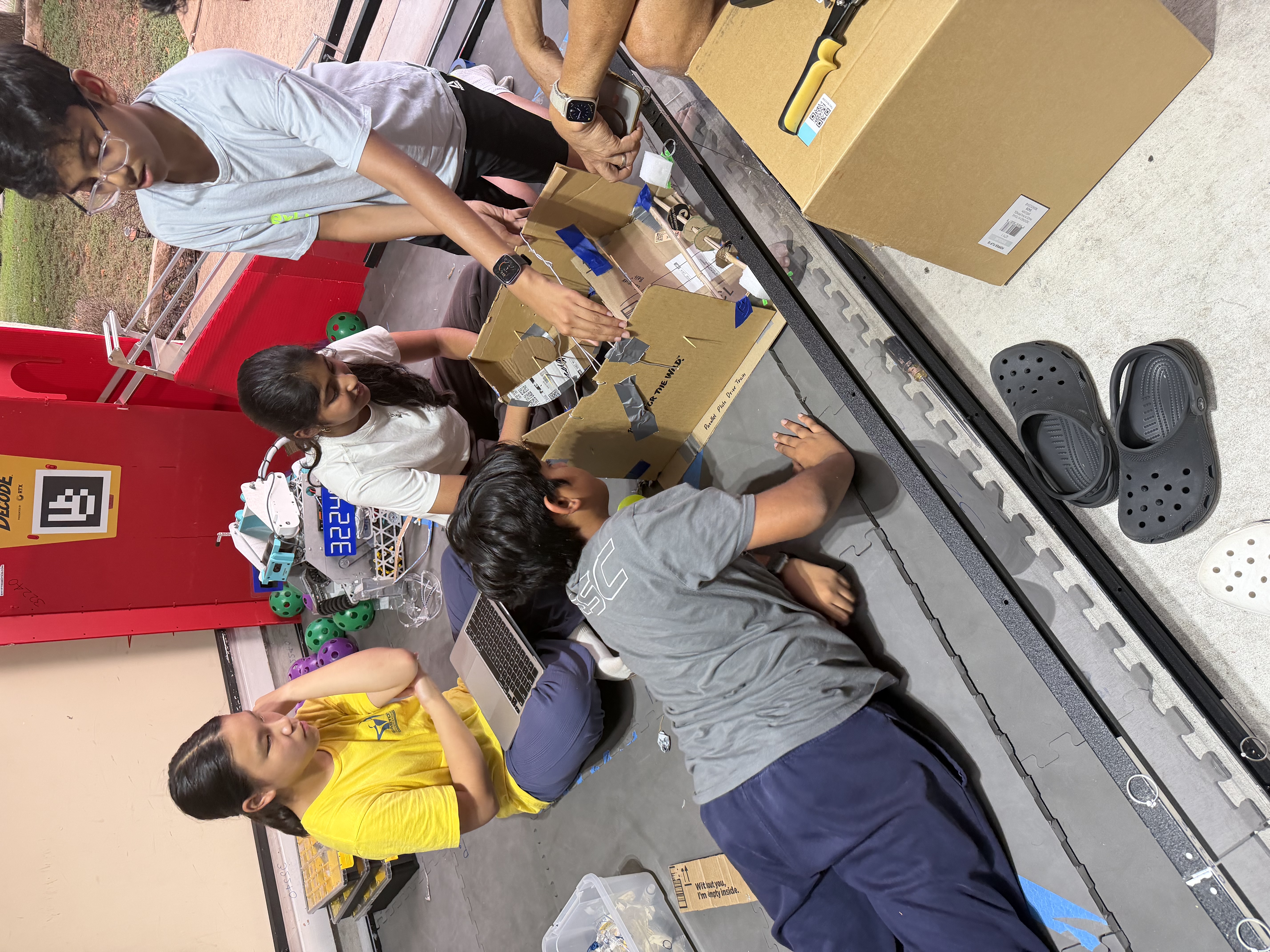 Penguinauts team members build a cardboard prototype together